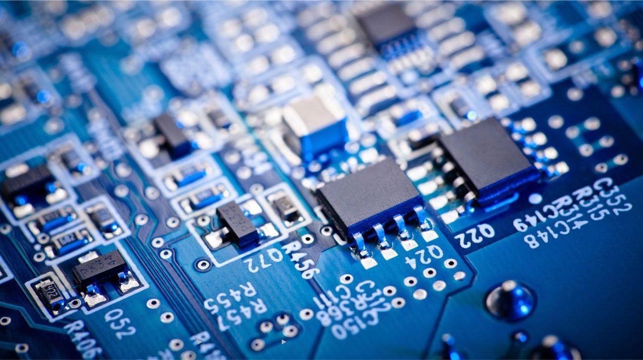 Close-up of a blue printed circuit board with electronic components